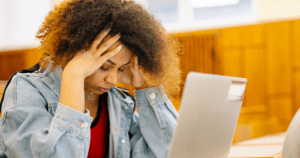 A university student on her laptop looking stressed
