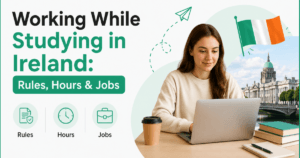A student working on her laptop with a coffee cup and stack of books on the table. The words: Working While Studying in Ireland: Rules, Hours & Jobs are on the side.