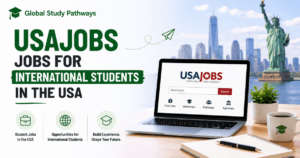A banner for global study pathways with the words: USAJOBS Jobs for International Students in the USA. On the side is a laptop on the table with USAJOBS on it and a pen and paper with a flower vase on the table.