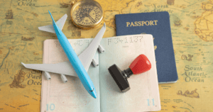 A minature plane, passport and stamp on the table to represent countries with the easiest student visa approval in 2026